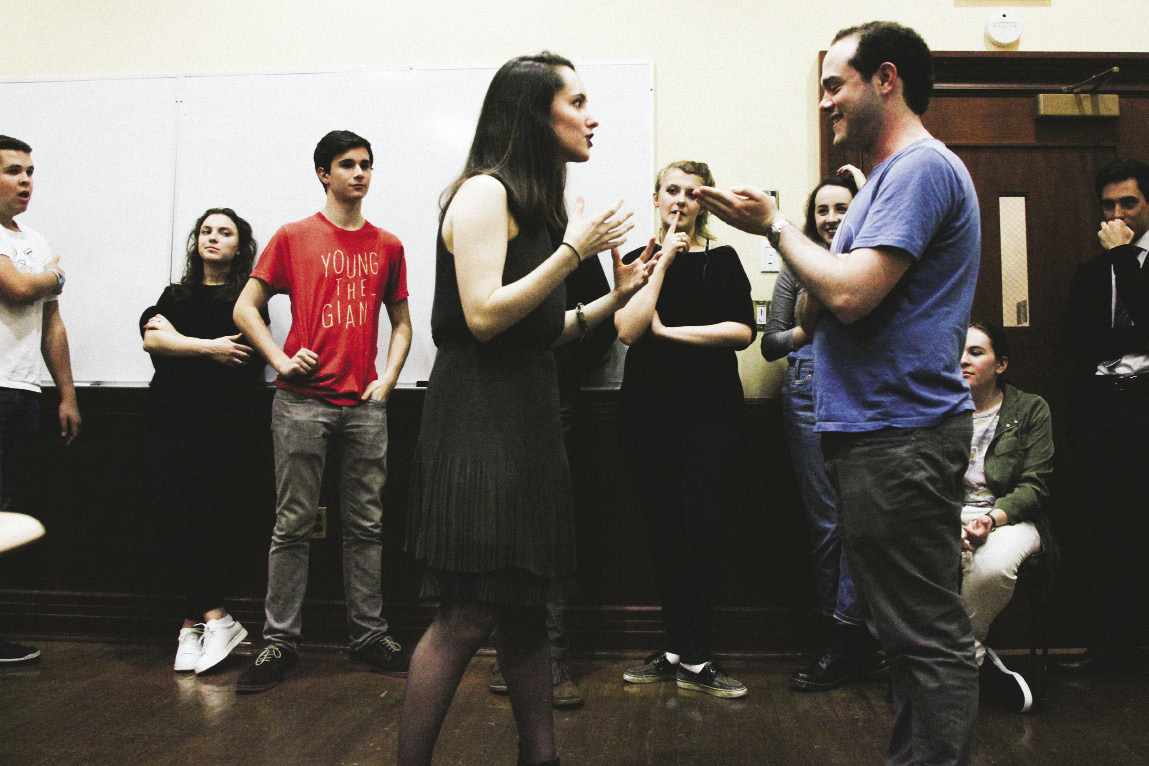 Woman and man speaking to each other in an improv class