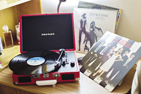 A portable turntable with an album on it