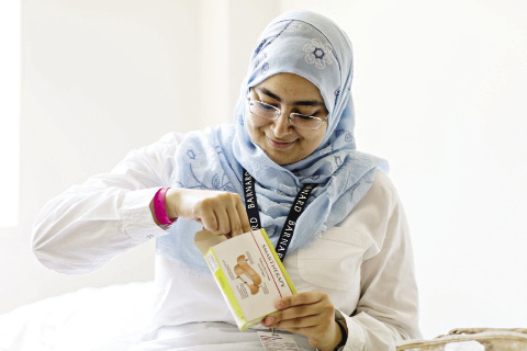 Tasneem Ebrahim opening a box of bandages