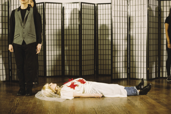 woman dressed as a bride lying on the floor