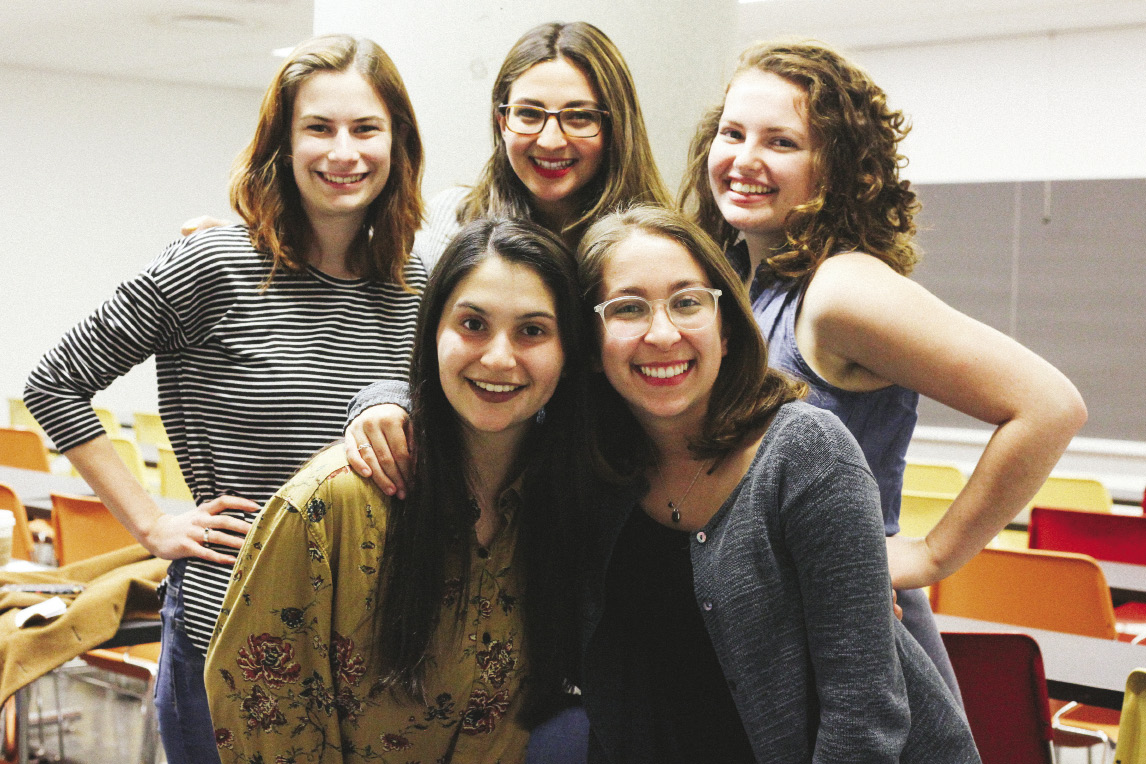 5 women in a classroom looking straight at the viewer