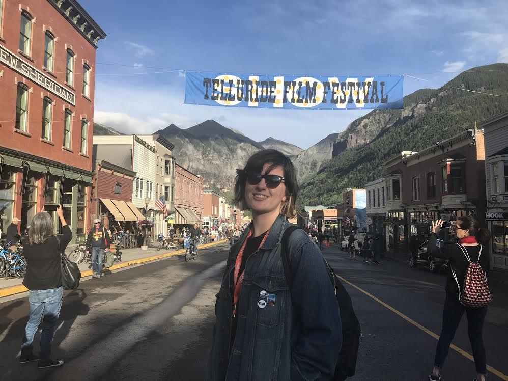 Post-Bac Fellow Ruby at the Telluride Film Festival, in front of the festival banner