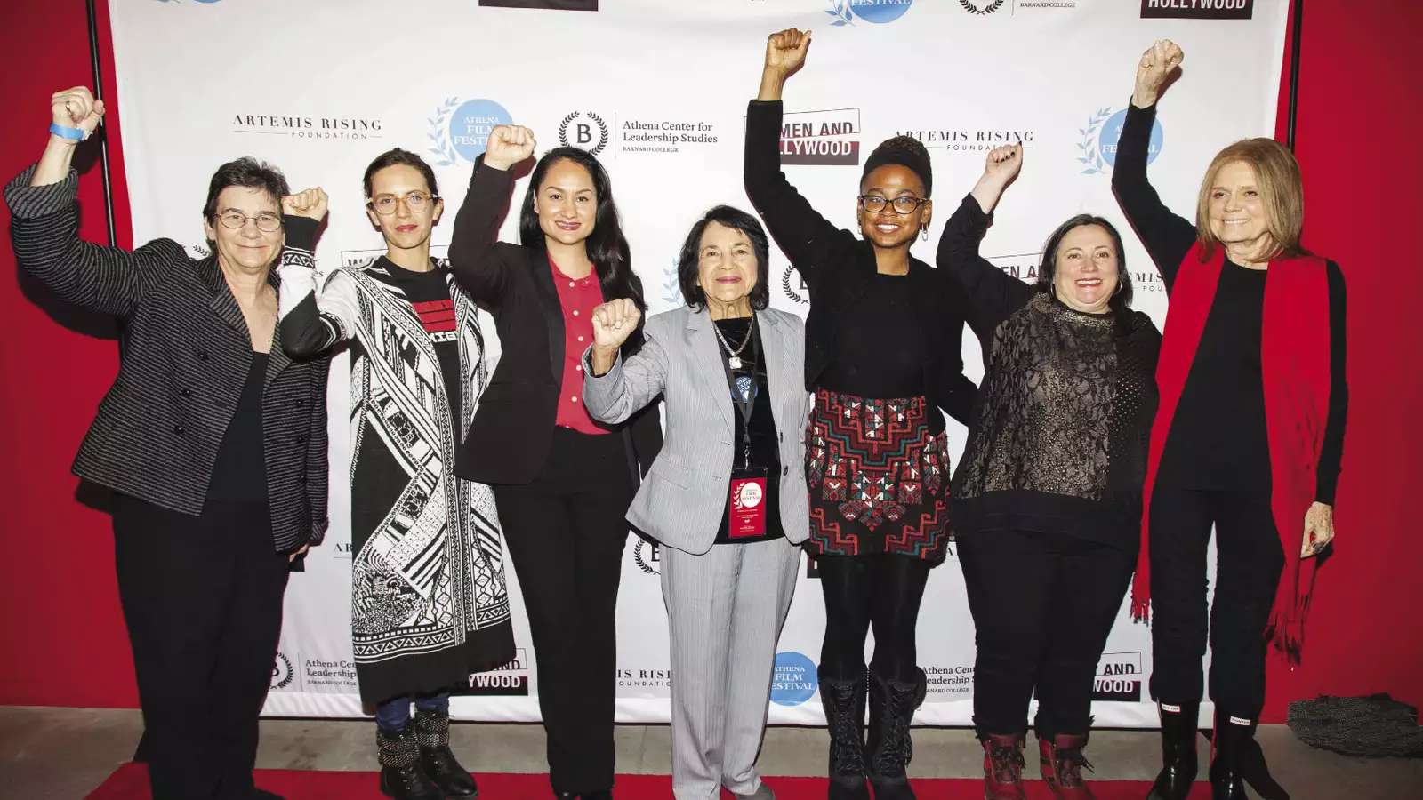 Several women raise a fist at the Athena Film Festival