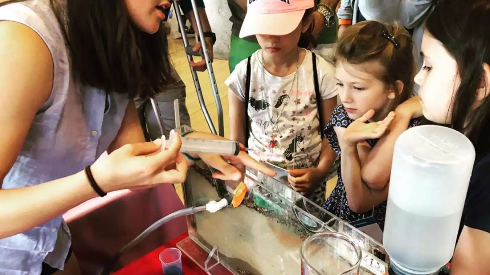 Scientist demonstrating tools to children