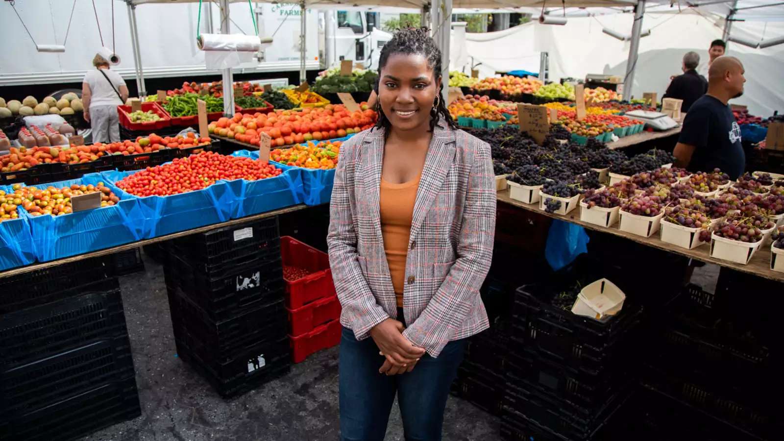 Olivia Watkins stands at a food stand 