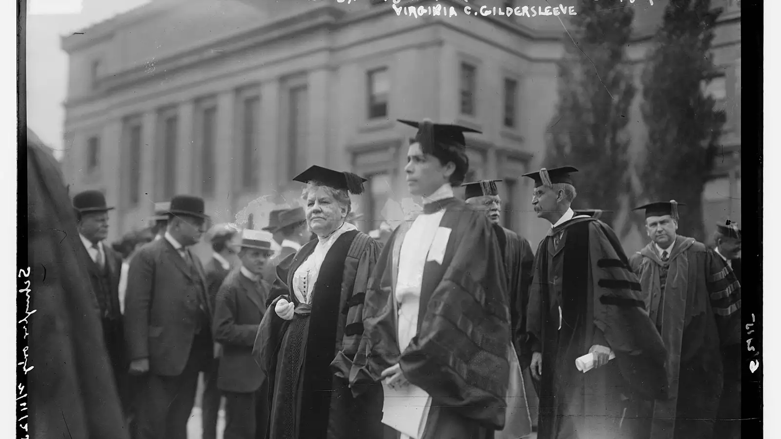 Gildersleeve stands with other faculty and administration members during a Columbia commencement event. Low Library can be seen in the background