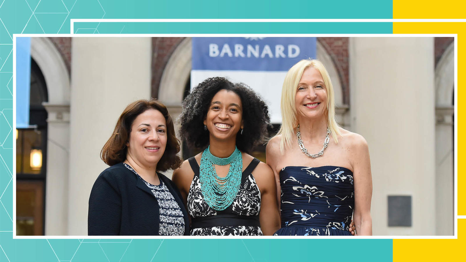 Three alumnae posing and smiling in front of Barnard Hall