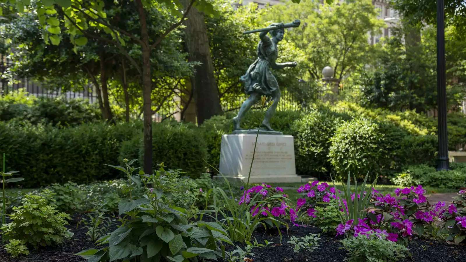 Barnard runner statue on campus in summer