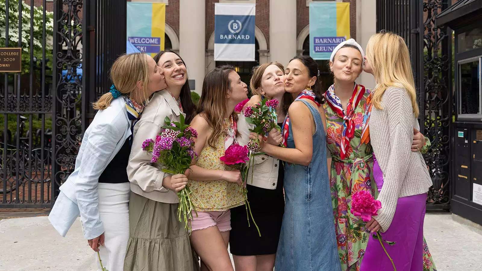 Members of the Class of 2013 give each other a kiss at the college's main gate