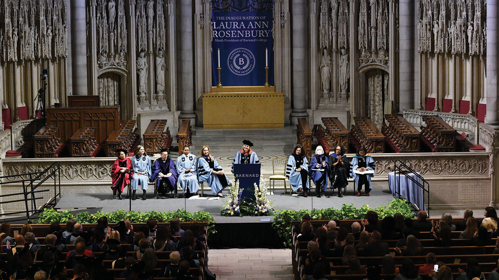 Wide photo of Laura Rosenbury speaking from the dais at Riverside Church at her inauguration as president of Barnard.