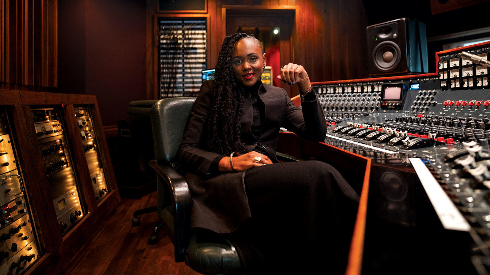 Ebonie Smith sits at music control panel 