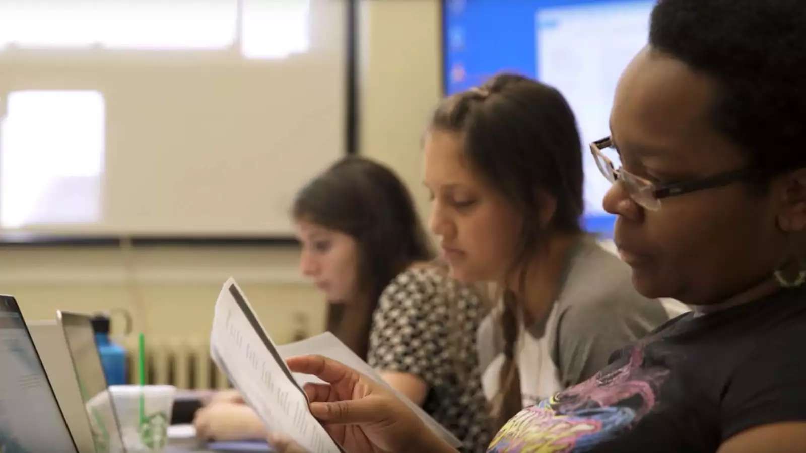 Students in class, reading quiz questions