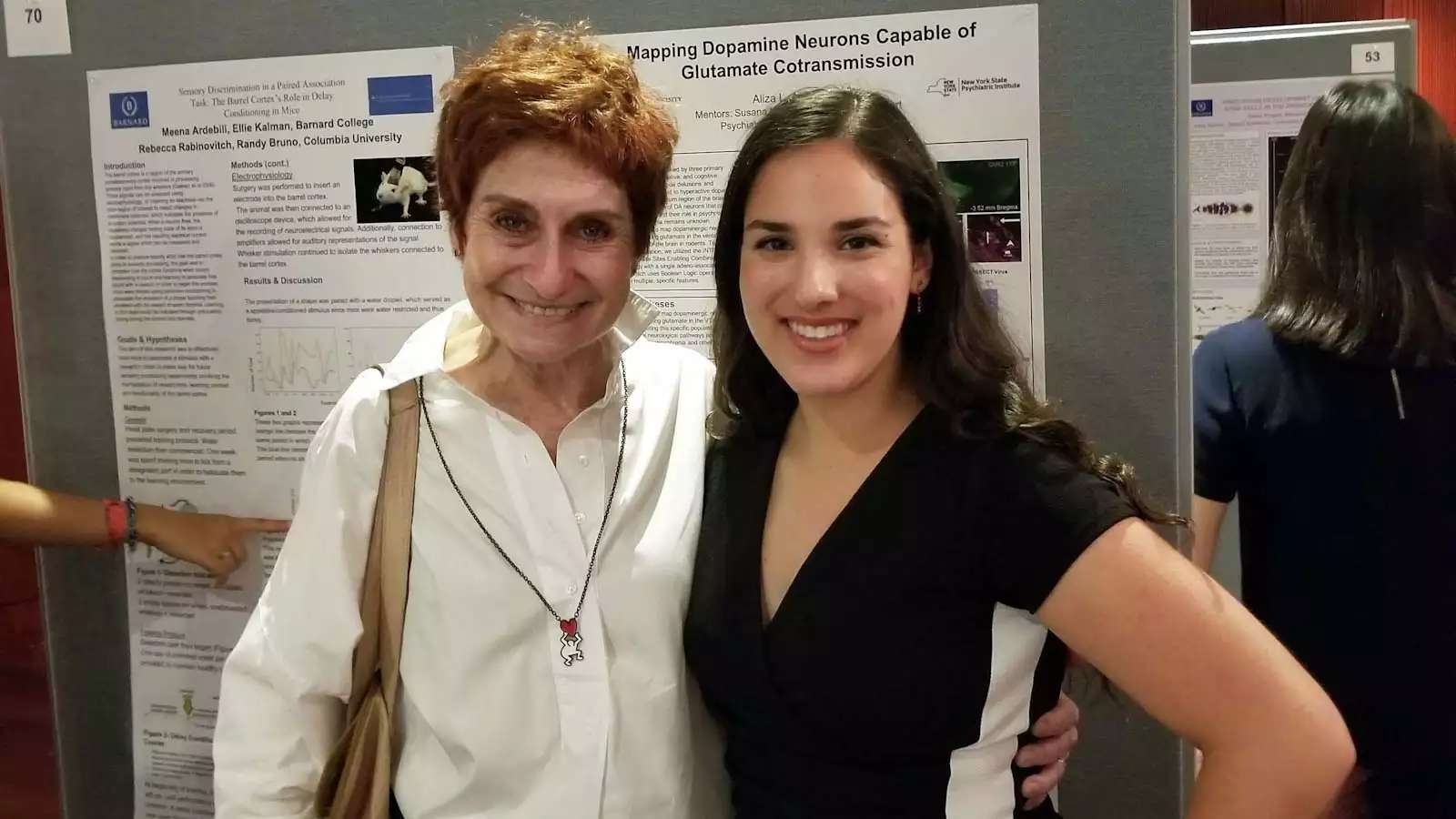 Two women side by side, smiling warmly