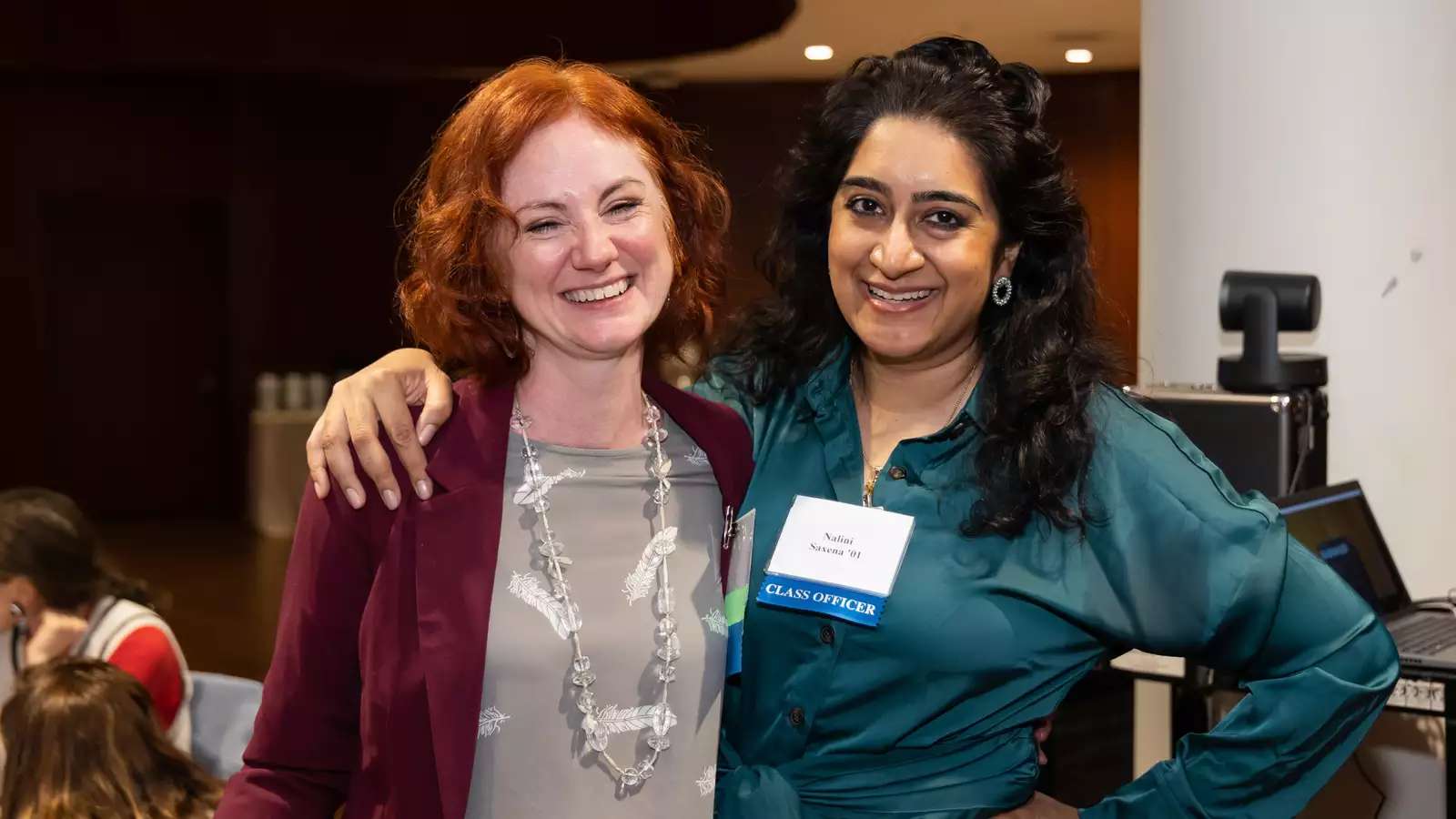 Two Barnard College alumnae smiling at an event