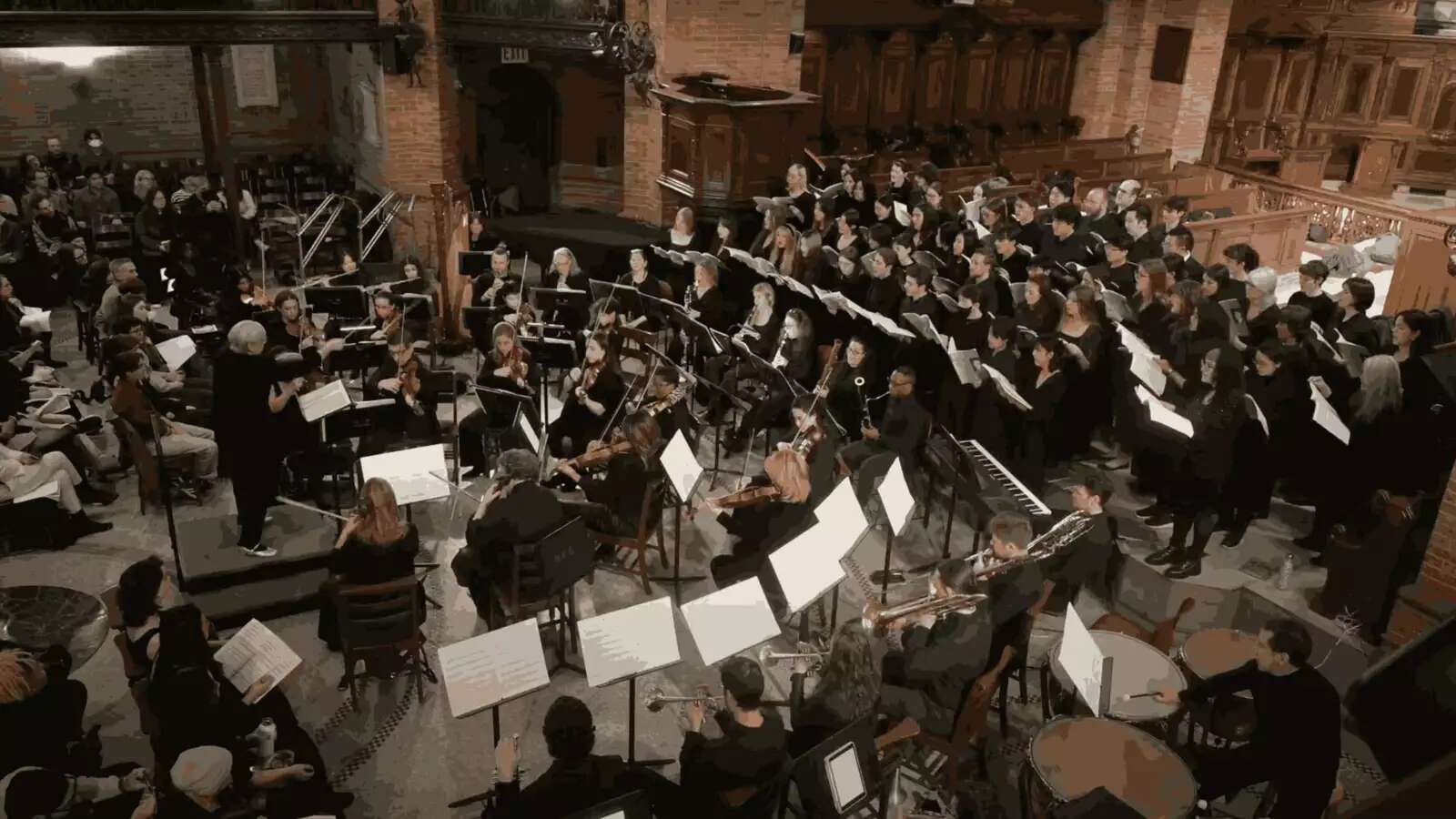 Professor Archer conducting a large orchestra