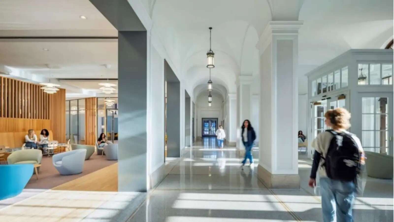 A shot of students walking through a hallway at the front of the Wellness Commons in the Francine LeFrak Center for Well-Being
