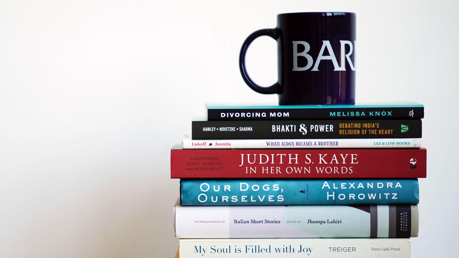 short stack of books with a coffee mug on top