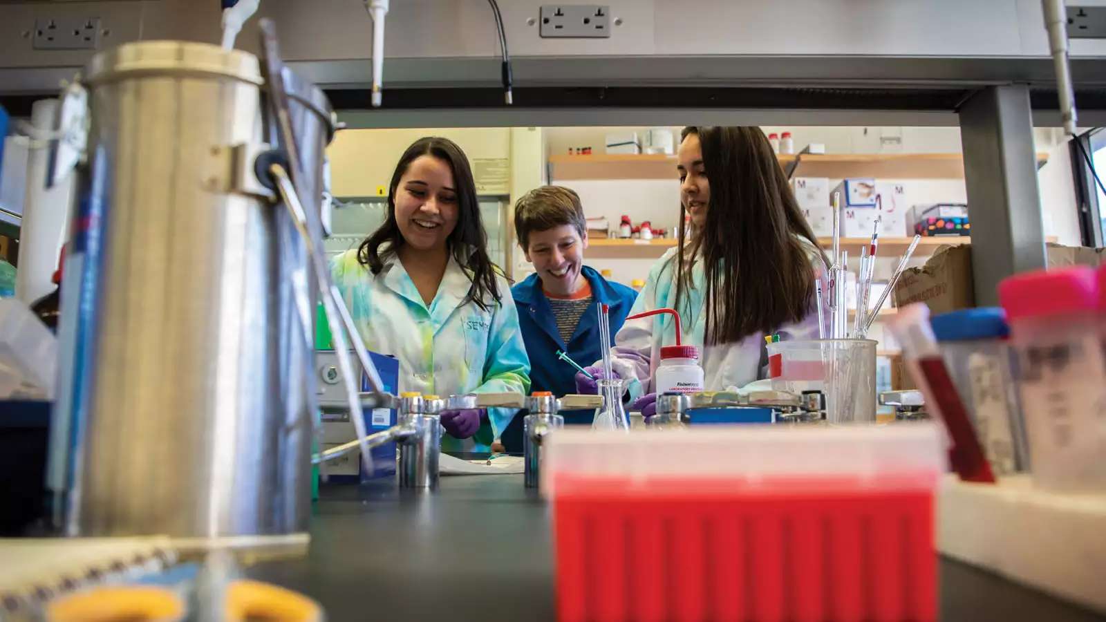 students and advisor in chem lab