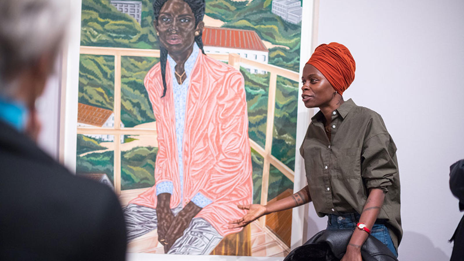 Toyin Ojih Odutola in front of one of her paintings