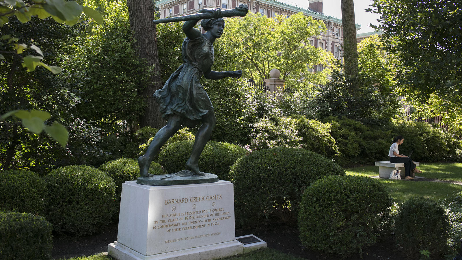 statue of a woman running in a shady green space on Barnard's campus