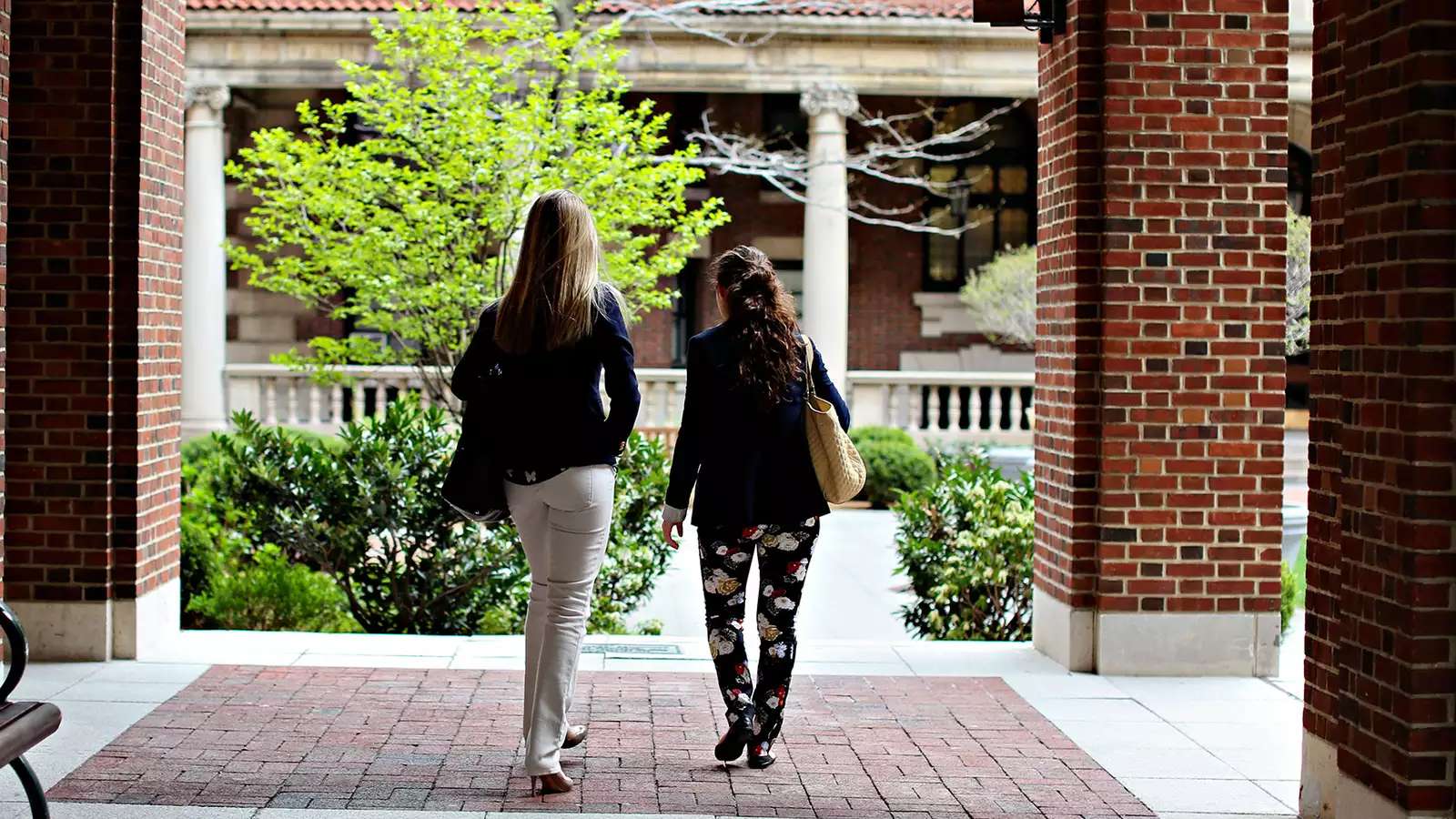 2 students walking on campus