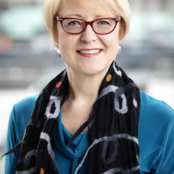 Woman with blonde hair and glasses