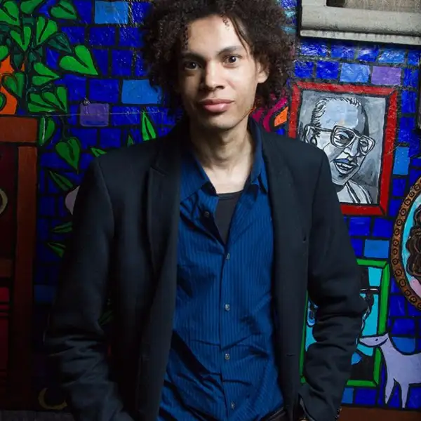 a Black man with natural hair looking directly at the camera