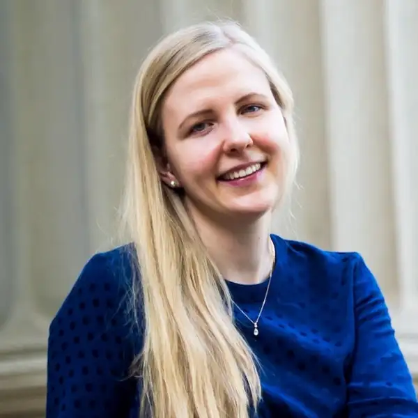 Photo of Prof. Alisa Knizel wearing a blue hair and showing her long blond hair.