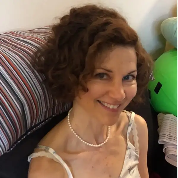 Woman with short hair sitting on a couch