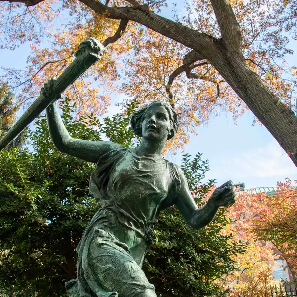 Athena Statue against autumn leaves. 