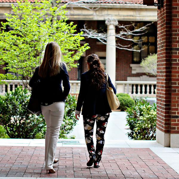2 students walking on campus