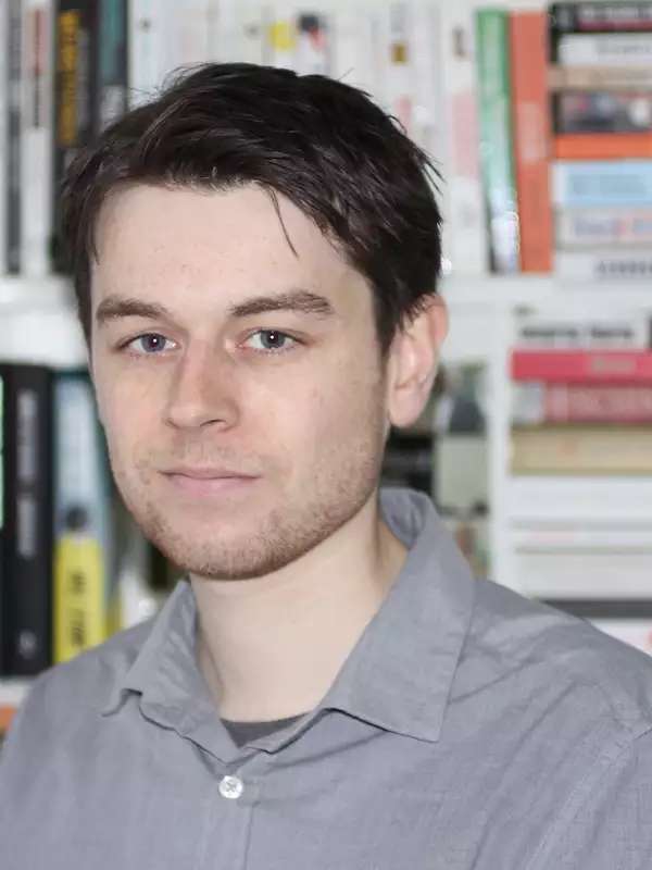 Rob Brotherton in front of bookcase