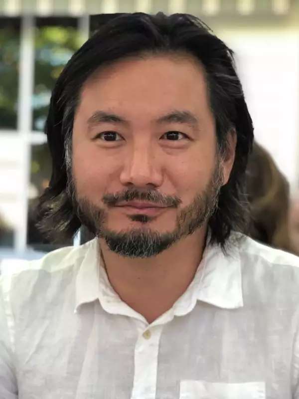 Image of an Asian man with shoulder length hair: Ken Chen, Associate Director of Creative Writing