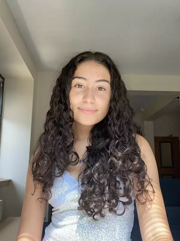 Sherlyn in front of a window, smiling at the camera