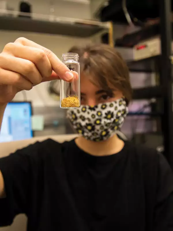 student holding test tube