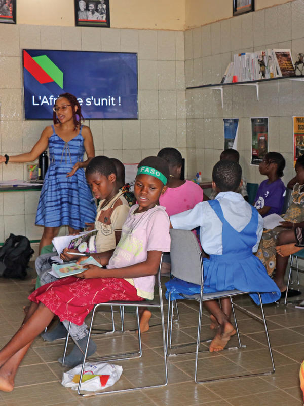 A classroom in West Africa with a teacher and a dozen children