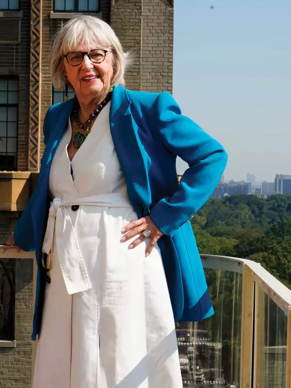 Harriet Newman Cohen standing on a balcony