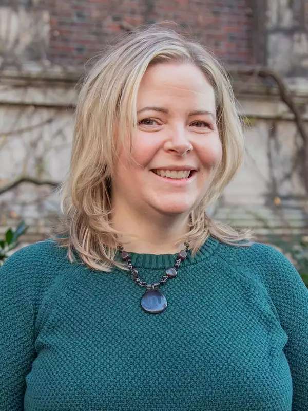 mixed background with woman smiling, blonde hair, wearing green sweater
