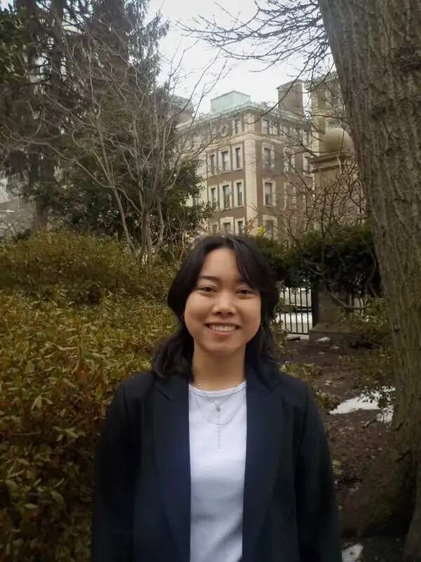 A smiling student standing outdoors.
