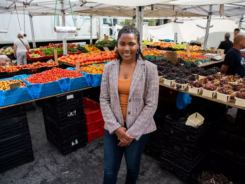 Olivia Watkins stands at a food stand