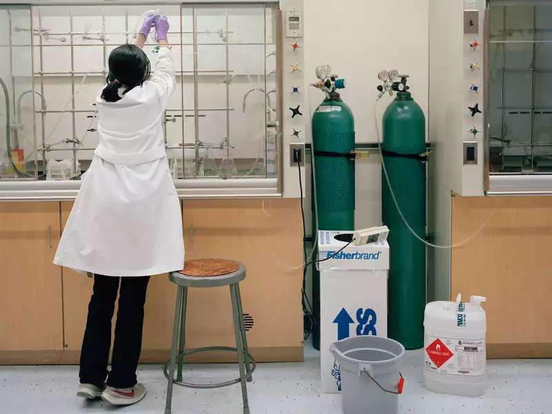 student in lab coat in the lab