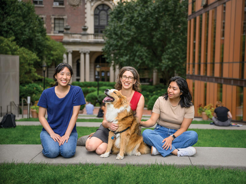 Alexandra Horowitz posing with students and a dog