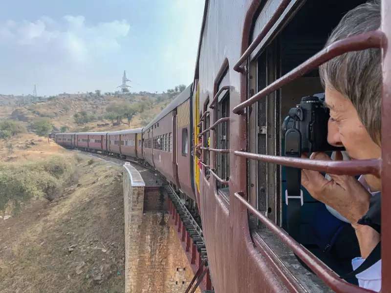 Photographer shooting out a train window