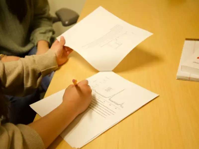 Writing Fellow's hands working with students