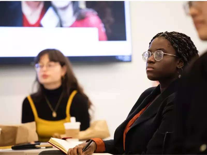 Barnard students in a panel discussion listening to a speaker