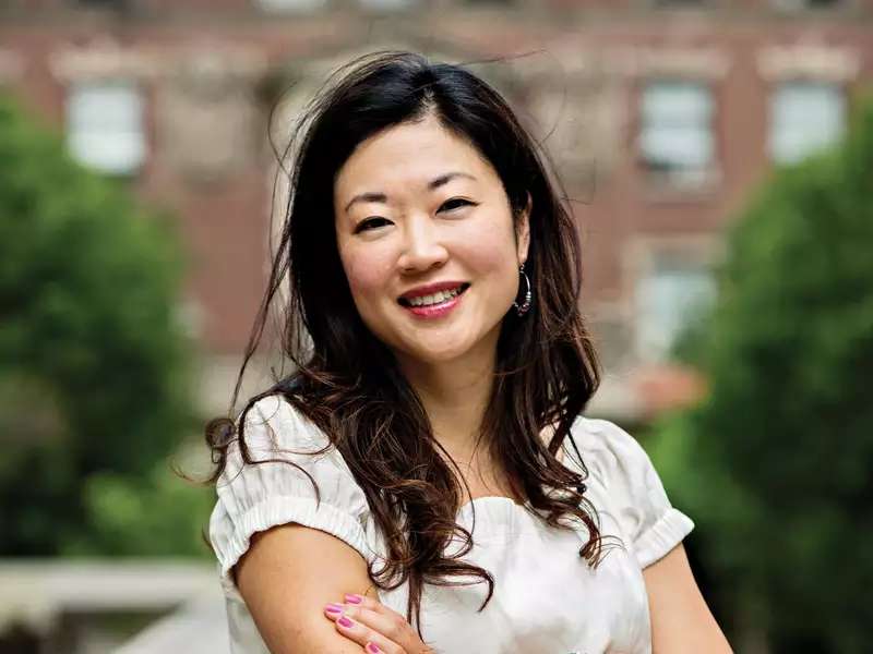 Sooji Park headshot on campus. She is wearing a white dress and has her arms crossed