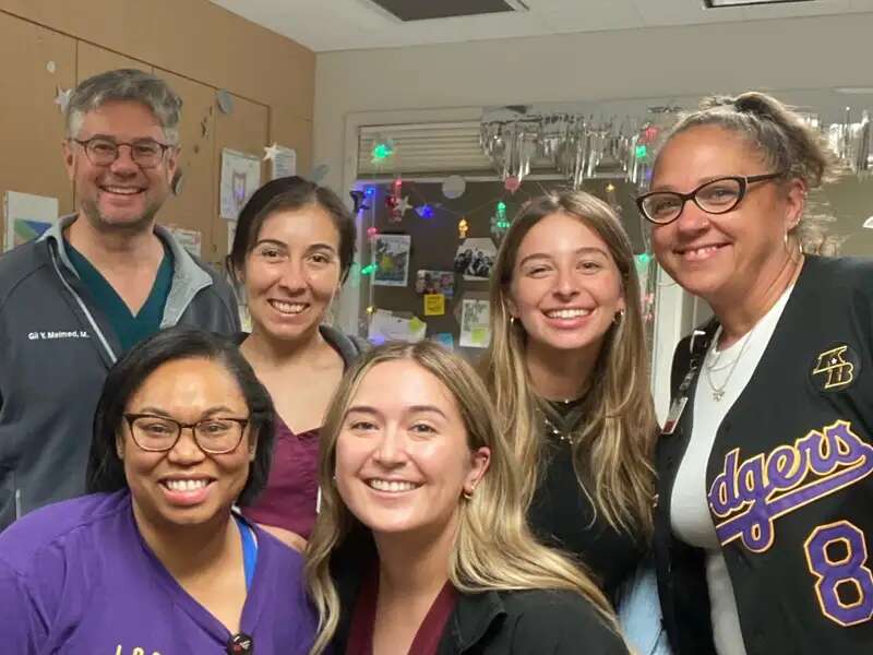 Rebecca poses with her coworkers. 