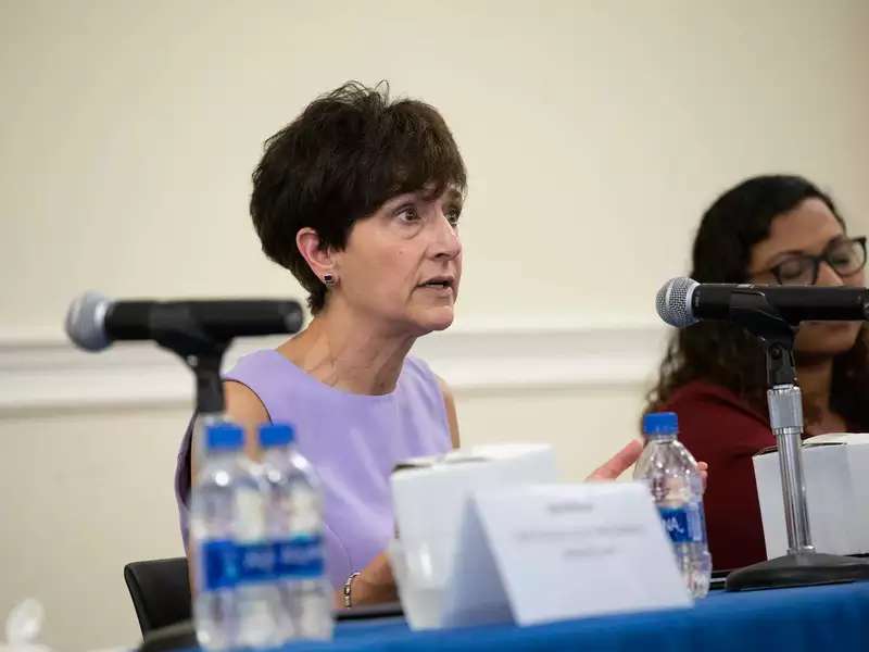 White woman speaking at an event
