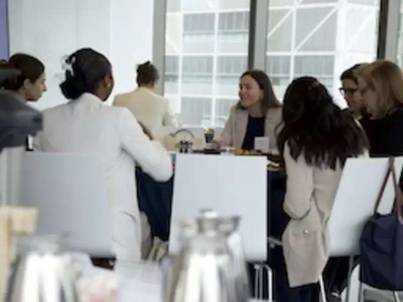 Barnard alums eating together in an events space