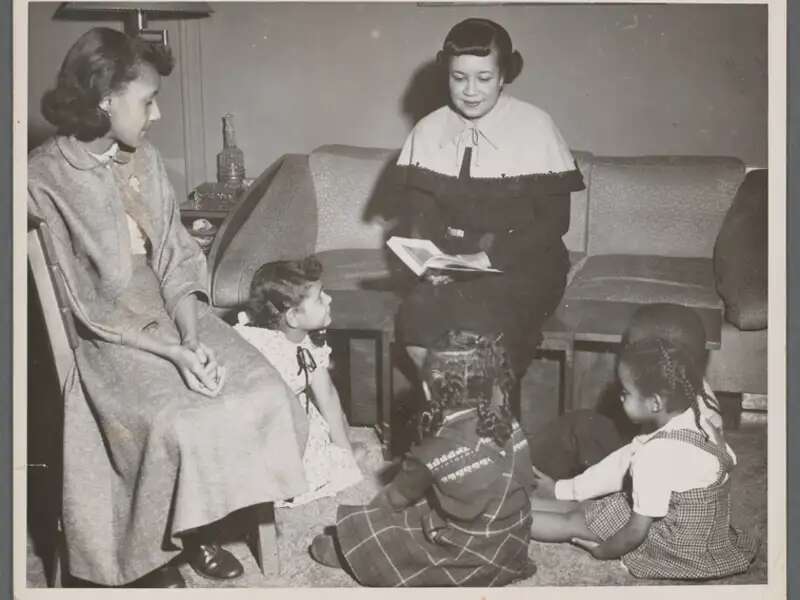 Woman reading to children
